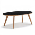 Owalny stolik kawowy 120 x 60 x 45 cm, czarny blat MDF, nogi z naturalnego dębu